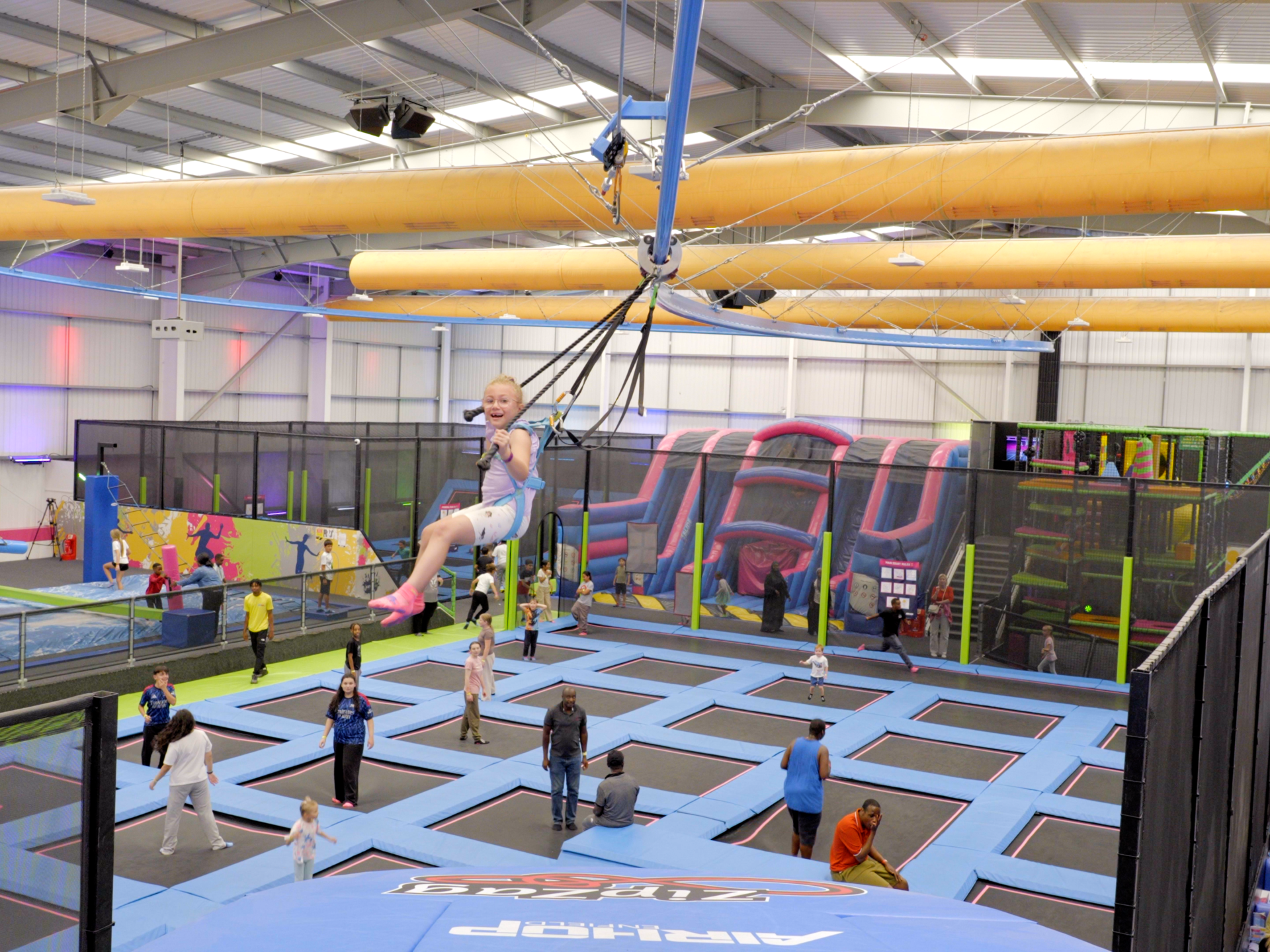 Child enjoying riding the AirGlider zipcoaster ride at AirHop Enfield